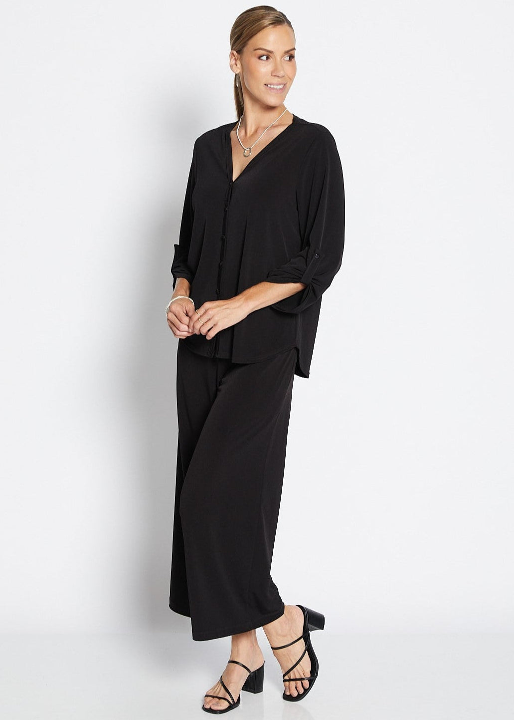 Woman wearing a black outfit on a white background