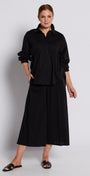 Person wearing a black outfit against a white background