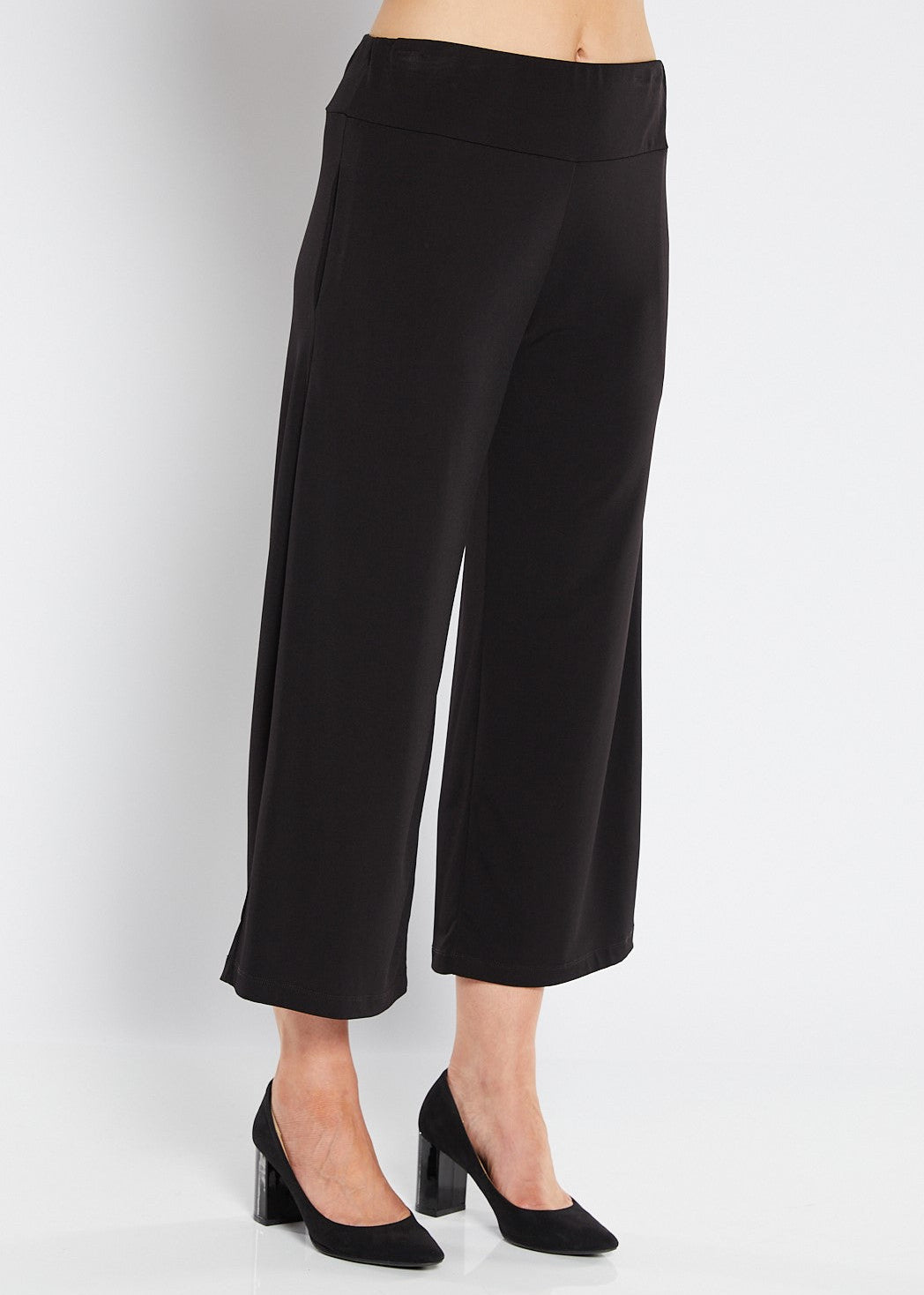 Black wide-leg pants worn by a person on a white background