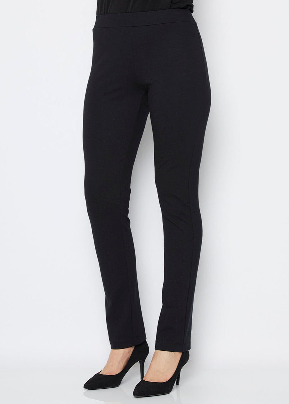 A model wearing black full length straight leg ponte pants with an elastic waistband.