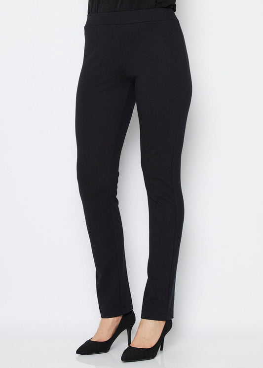 A model wearing black full length straight leg ponte pants with an elastic waistband.