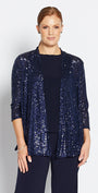 Woman wearing a navy sequin jacket, navy top, and wide-leg pants on a white background