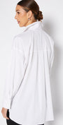 Woman wearing a white shirt against a plain background