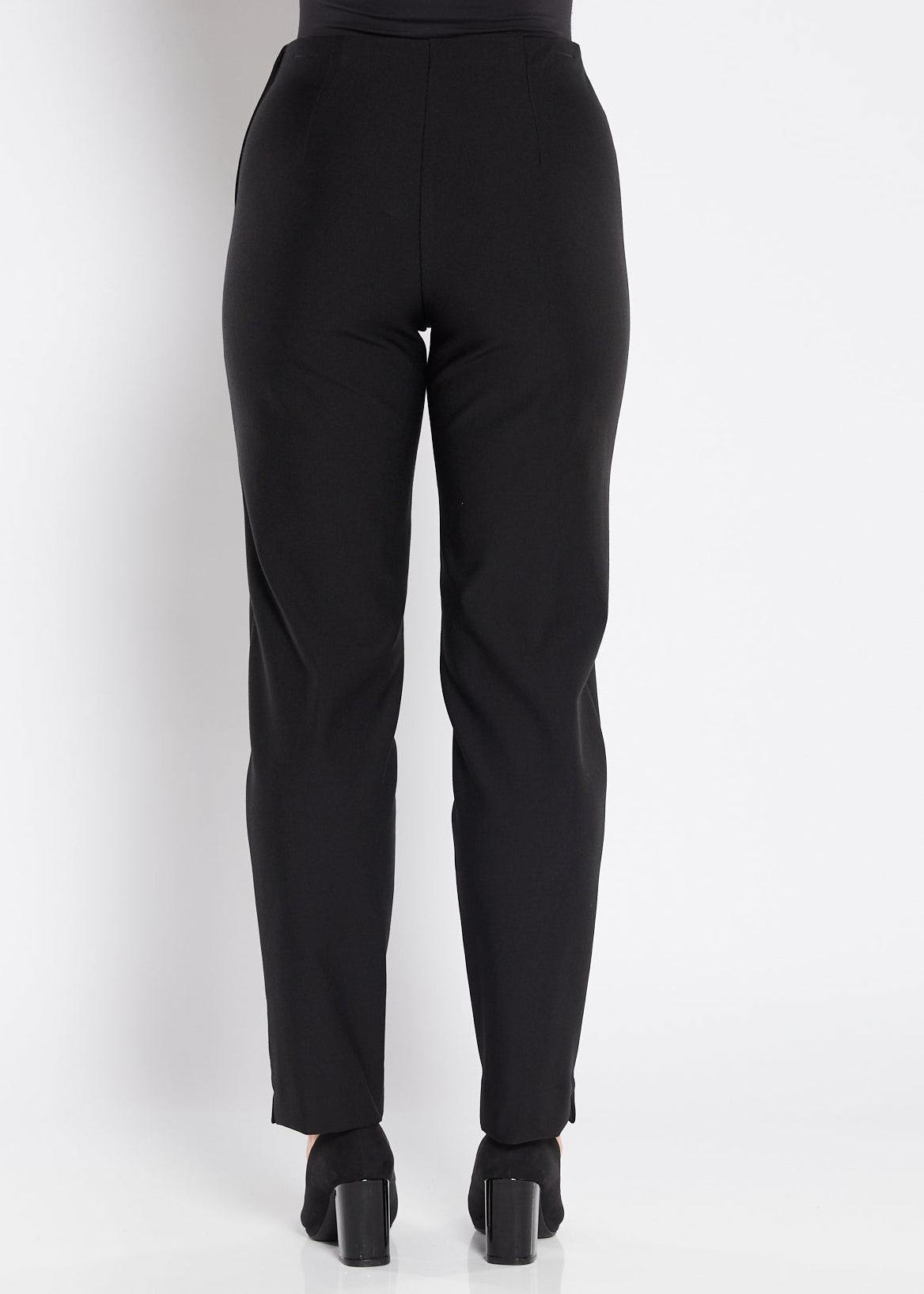 Black pants worn by a person on a white background