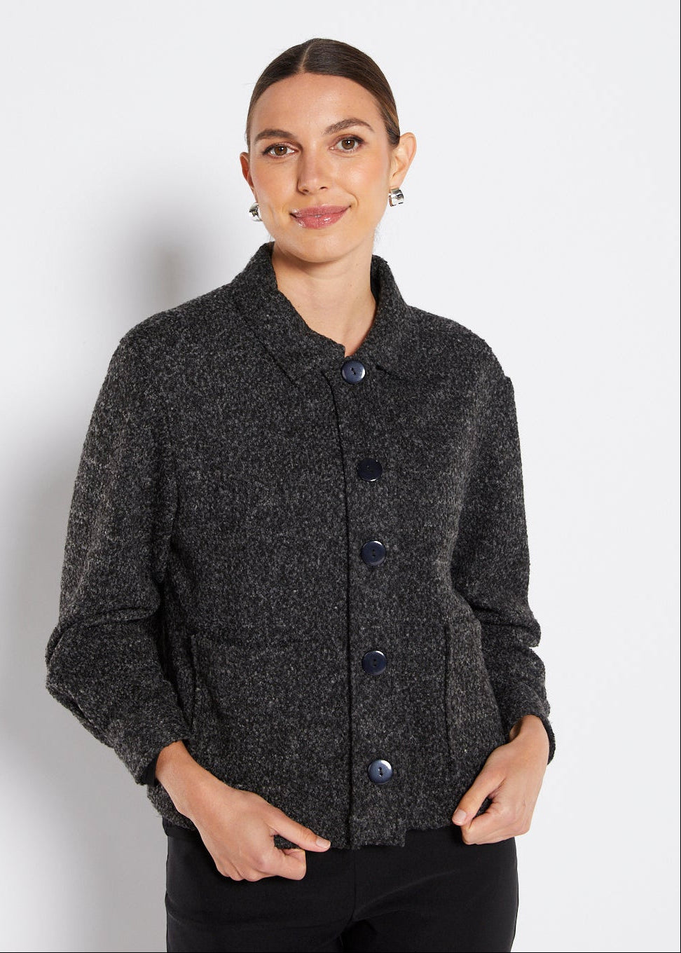 Woman wearing a dark gray textured jacket on a white background