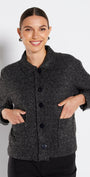 Woman wearing a gray textured jacket on a white background