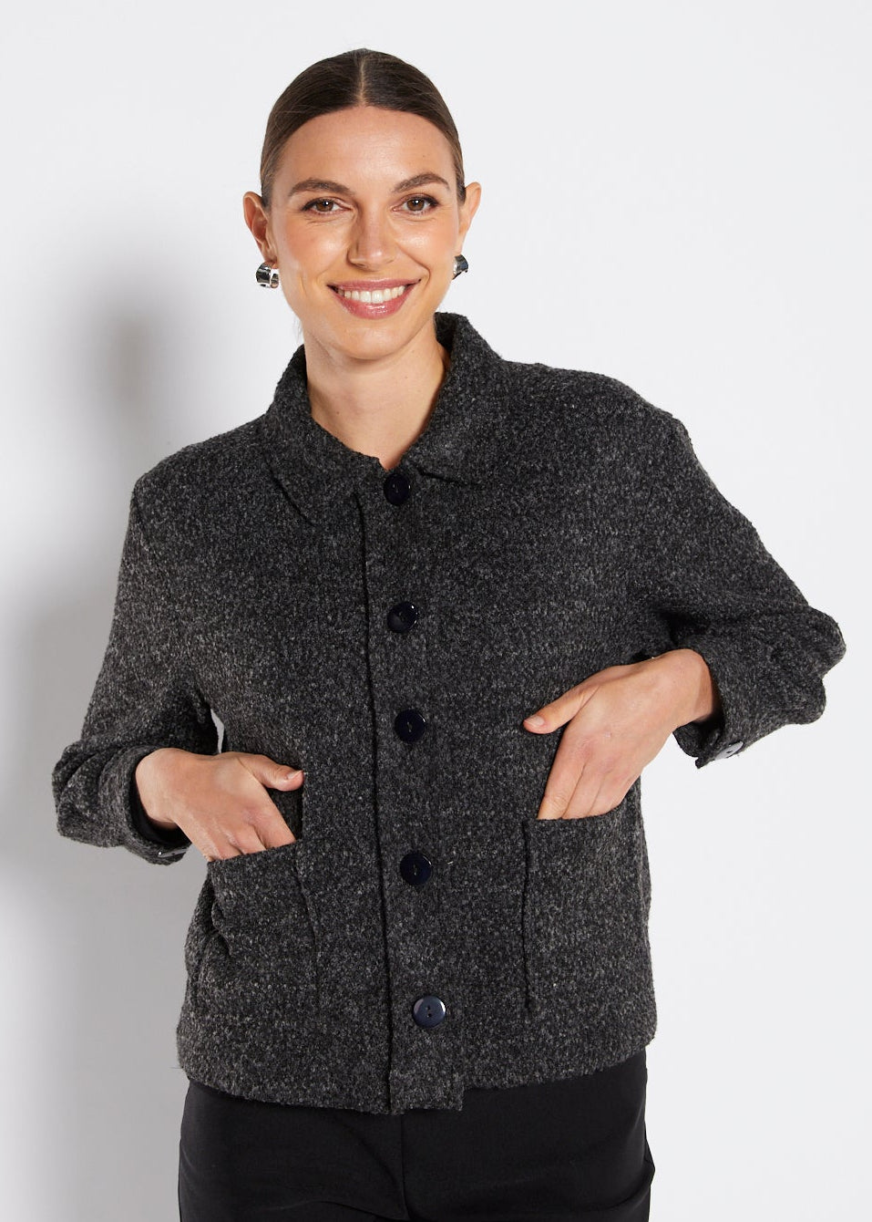 Woman wearing a gray textured jacket on a white background
