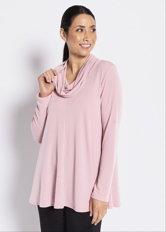 Woman wearing a pink long-sleeve top against a white background