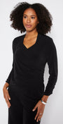 Woman wearing a black outfit against a white background
