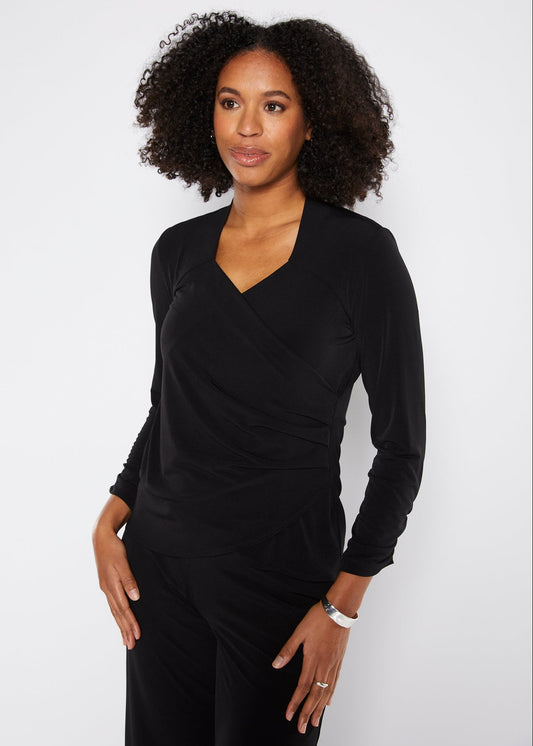 Woman wearing a black outfit against a white background