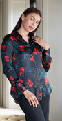 Woman wearing a dark floral blouse in a room with neutral decor