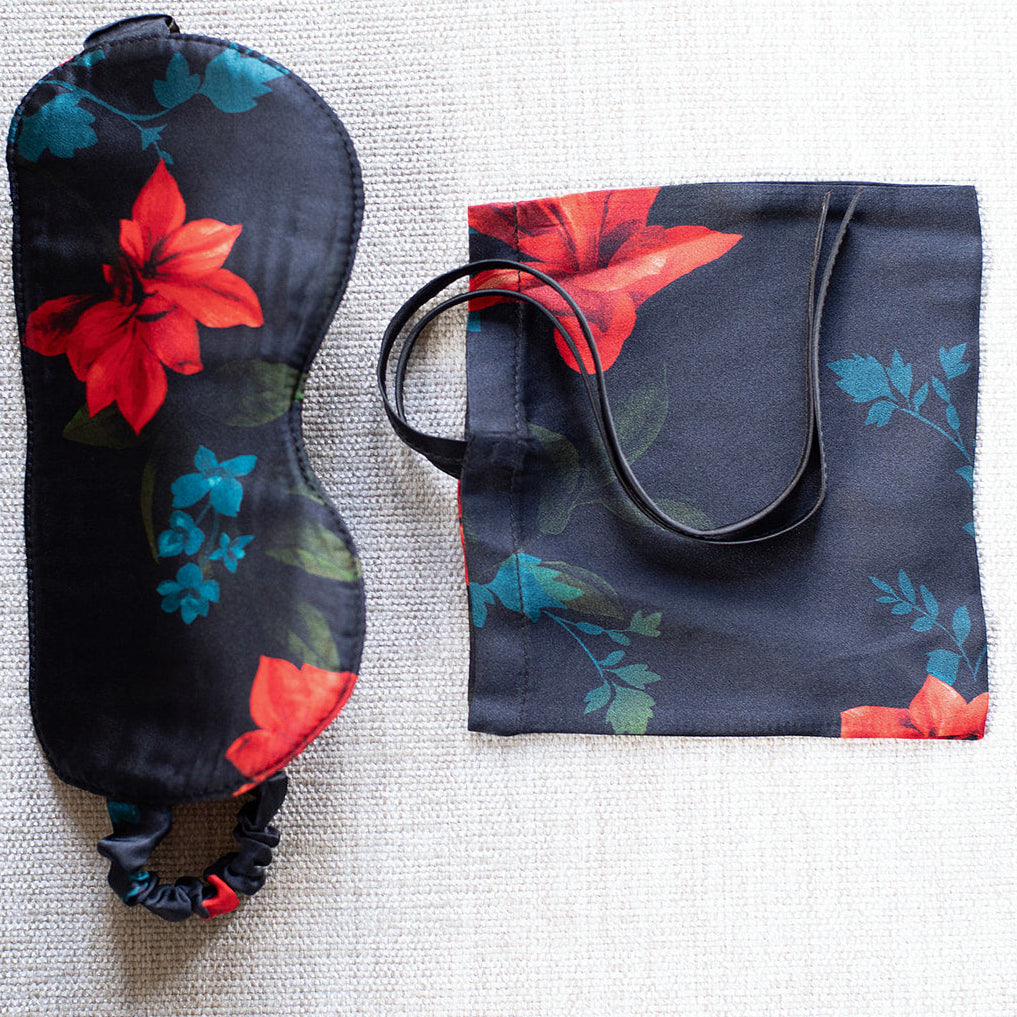 Floral-patterned sleep mask and pouch on a textured surface