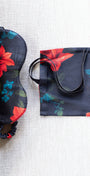 Floral-patterned sleep mask and pouch on a textured surface