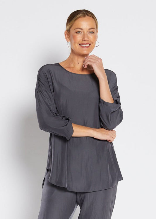 Woman wearing a gray outfit on a white background