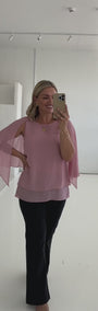 Model wearing pink chiffon shirt with black bengaline pants