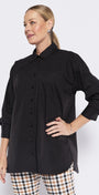 Woman wearing a black shirt and checkered pants on a white background