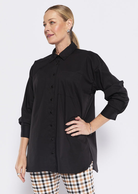 Woman wearing a black shirt and checkered pants on a white background