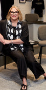 Woman sitting on a chair in a clothing store