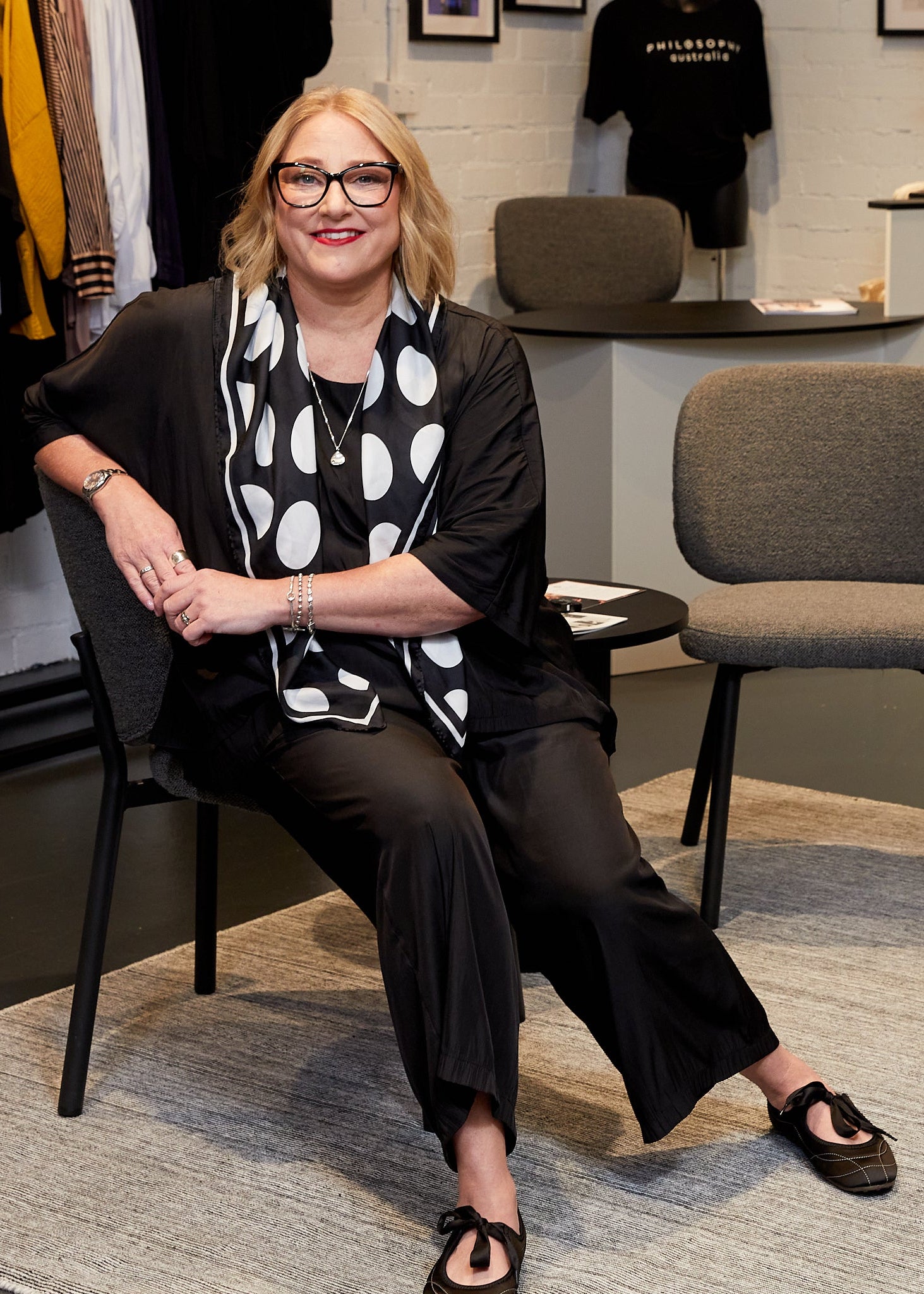 Woman sitting on a chair in a clothing store