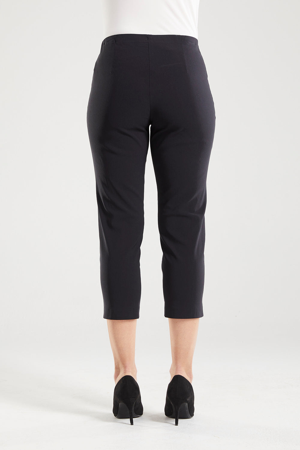 Adora is a Spring Summer 3/4 cropped black pant. Cut at calf length, with an easy comfortable pull on elastic waist and slim legs. Image is back view of model. Philosophy Australia bengaline 3/4 length pant.