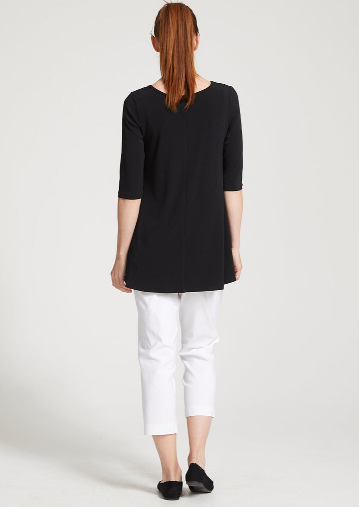 Adora is a Spring Summer 3/4 cropped white pant. Cut at calf length, with an easy comfortable pull on elastic waist and slim legs. Image is back view of model. Philosophy Australia bengaline 3/4 length pant.